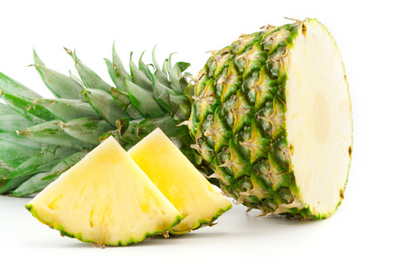 half pineapple and slices on a white backgroundの写真素材