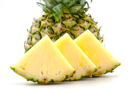 half pineapple and slices on a white backgroundの写真素材