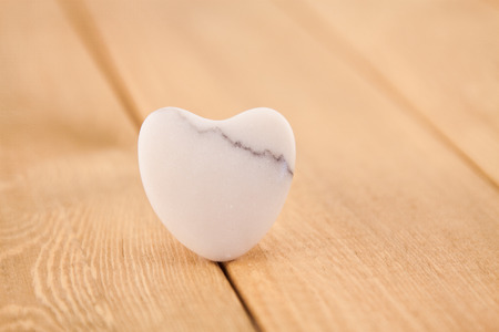 white stone heart on wooden planksの写真素材