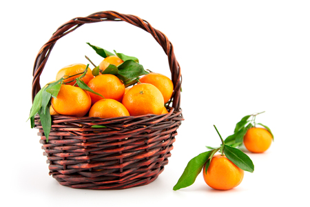 organic ripe mandarins in basket on white backgroundの写真素材