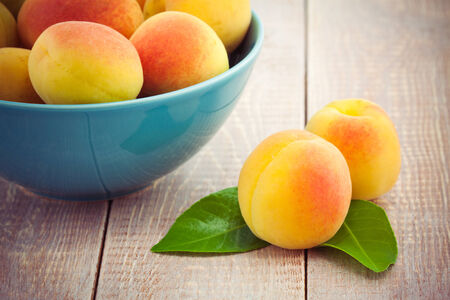 Juicy  fresh peaches on wooden tableの写真素材