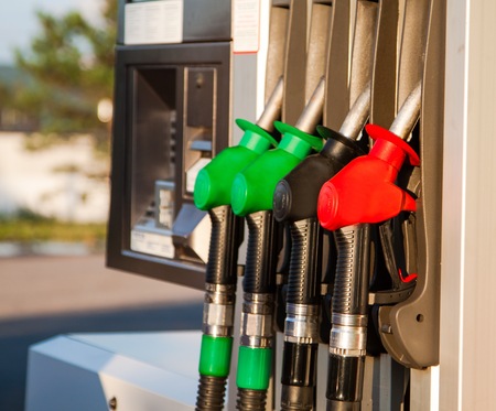 Red, green and black fuel pumps at petrol stationの写真素材