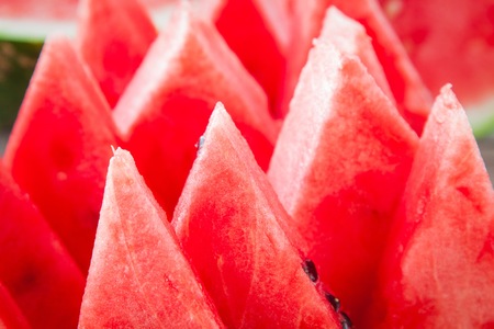 slices of fresh juicy organic watermelon closeup on a wooden background