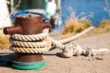 bollard with a rope tied to a pier