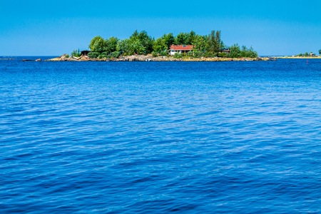 red cabin on an island in the seaの写真素材