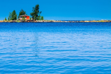 red cabin on an island in the seaの写真素材