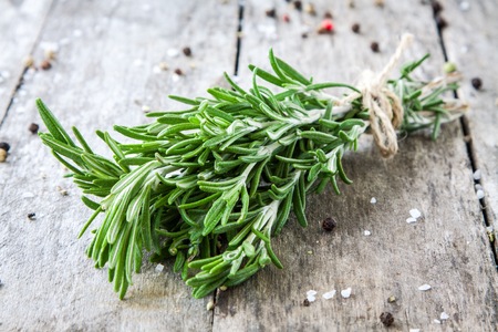 a bunch of fresh rosemary on a wooden backgroundの写真素材