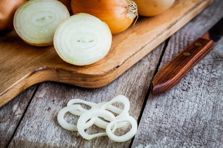 Fresh organic onions on a wooden backgroundの写真素材