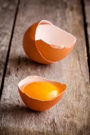Fresh farm eggs close-up on a wooden rustic backgroundの写真素材