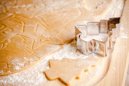 Gingerbread dough for Christmas cookies and cookie cutters.の写真素材