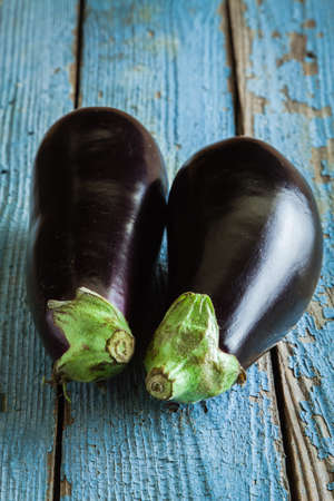 Two raw organic eggplant on old rustic wooden backgroundの写真素材