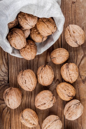 Fresh ripe walnuts on a wooden backgroundの写真素材