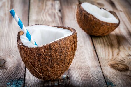 Fresh organic coconut on rustic wooden backgroundの写真素材