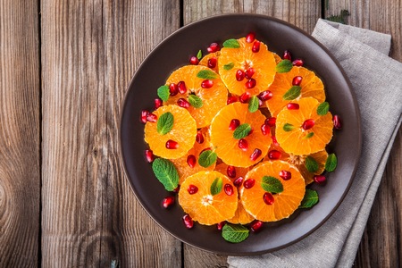 Fresh juicy citrus salad: tangerine, pomegranate and mintの写真素材