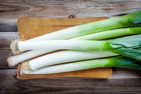 Fresh raw organic leek on a wooden tableの写真素材