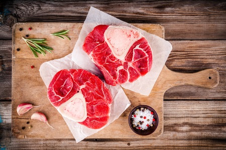 two raw fresh veal shank meat for ossobuco on wooden backgroundの写真素材