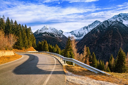 Mountain road and serpentines in Alps, Italyの写真素材