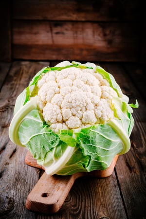 Fresh raw organic cauliflower on a wooden rustic backgroundの写真素材