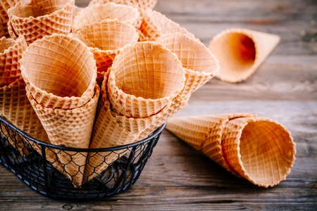 Ice cream waffle cones on wooden backgroundの写真素材