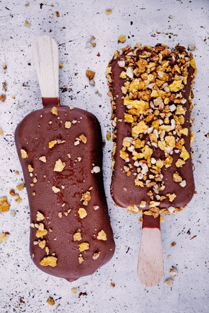 chocolate ice cream popsicle on rustic background