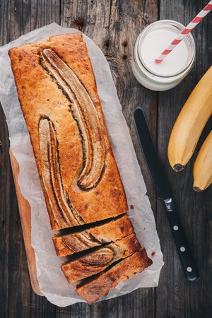 homemade banana bread on a wooden rustic backgroundの写真素材