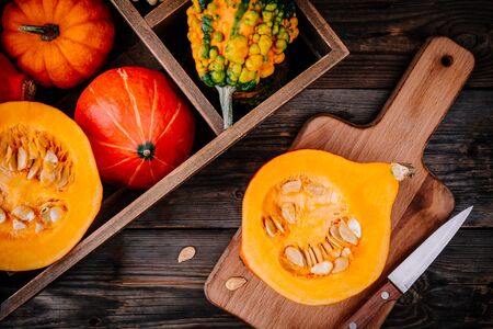 fresh raw autumn pumpkins on a wooden background. view from aboveの写真素材