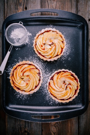 traditional pies apple tarts on wooden backgroundの写真素材