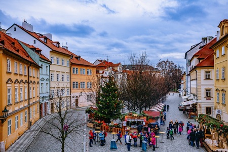 RAGUE, CZECH REPUBLIC - DECEMBER 22, 2015: Wooden stands offering souvenirs and traditional food during Christmas market taking place each year on December in Old Town of Prague, Czech Republic.のeditorial素材
