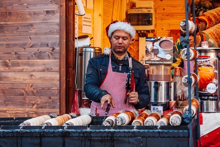 PRAGUE, CZECH REPUBLIC - DECEMBER 23, 2015: Trdelnik is street food of Prague.  Trdlo is tubes of sweet dough, cooked on an open fire, Prague, Czech Republic.のeditorial素材