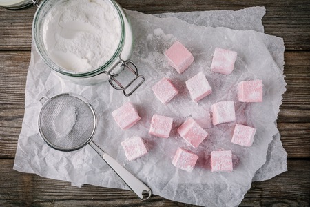Homemade strawberry marshmallows on wooden background. Top viewの写真素材