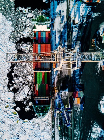Industrial port with containers in winter, vessel loading in port of Finlandの写真素材