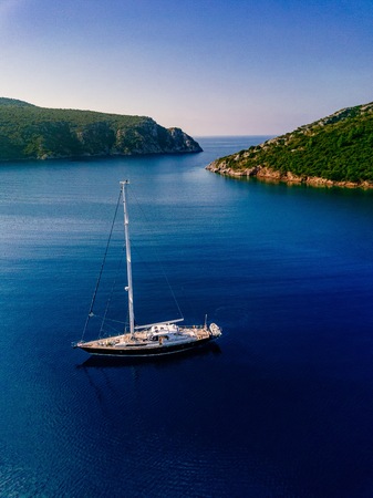 Aerial view to Yacht in deep blue sea. Drone photographyの写真素材