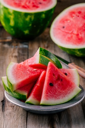Fresh ripe sliced watermelon on wooden rustic backgroundの写真素材