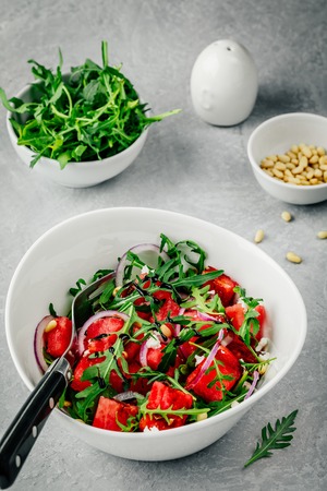 Fresh summer salad. Watermelon with feta, arugula, onion, pine nuts and balsamic sauce.の写真素材