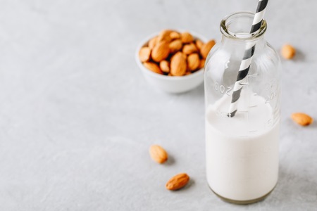 Homemade almond milk in a glass bottle. Organic vegan milkの写真素材