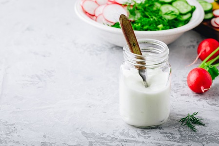 Homemade yogurt salad dressing in glass jarの写真素材