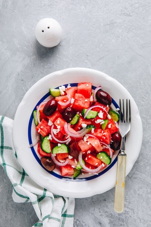 Fresh summer watermelon salad with feta cheese, cucumbers, olives and red onions. Top viewの写真素材