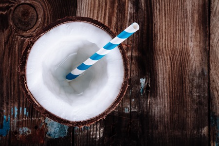 Fresh organic coconut water on rustic wooden backgroundの写真素材