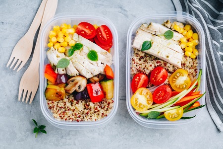 Meal prep lunch box containers with quinoa, grilled and fresh vegetables and chickenの写真素材
