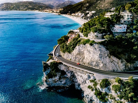 Aerial view of road going through beautiful summer landscape by the sea in Italyの写真素材