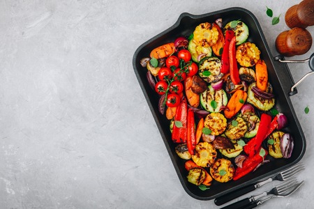Grilled vegetables in a cast iron pan. Top view, copy space