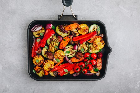 Grilled vegetables in a cast iron pan. Top view, copy space