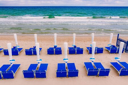 Umbrellas and sun beds on the beach at the Sea or ocean in a beautiful summer dayの写真素材