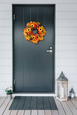 Thanksgiving Autumn wreath with sunflowers, pumpkins and maple leaves on front doorの写真素材