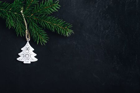 Christmas background with fir branch and christmas tree. Copy space, dark concrete stone background.の写真素材