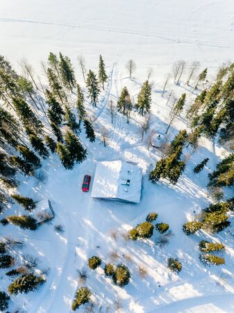 Aerial view of wooden log cabin or cottage in snow  winter forest by the lake in rural Finland Laplandの写真素材