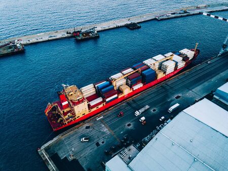 Aerial top view of industrial cargo container logistics ship in terminal in Italyの写真素材