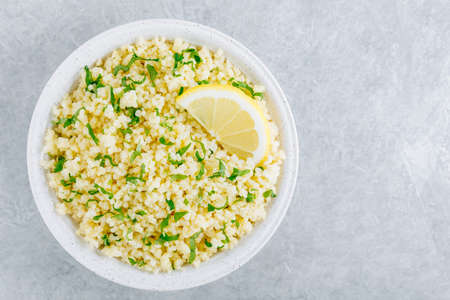 Lemon Herb Couscous in bowl on gray stone backgroundの写真素材
