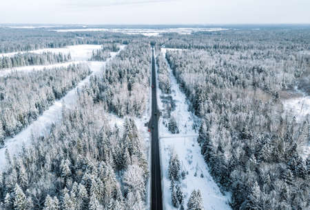 Aerial view of snow covered road in winter. Winter landscape, road and trees covered with snow.の写真素材