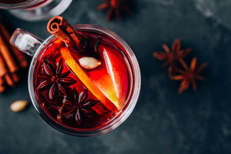 Christmas Mulled Wine with spices and fruits on a dark background, copy space. Traditional Hot Drink for Christmasの写真素材